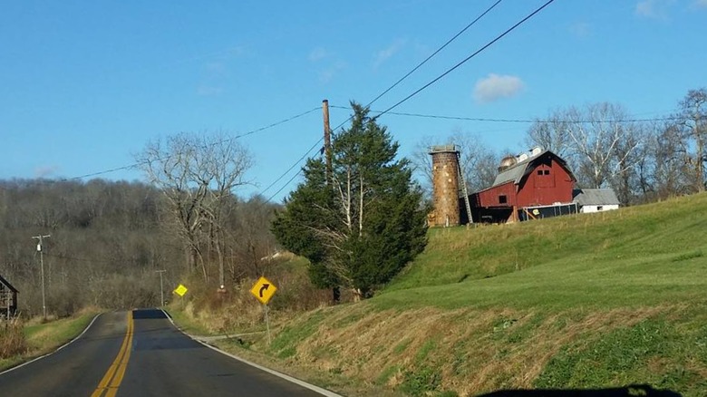 A mural red farmhouse and road outside Amesville, Ohio